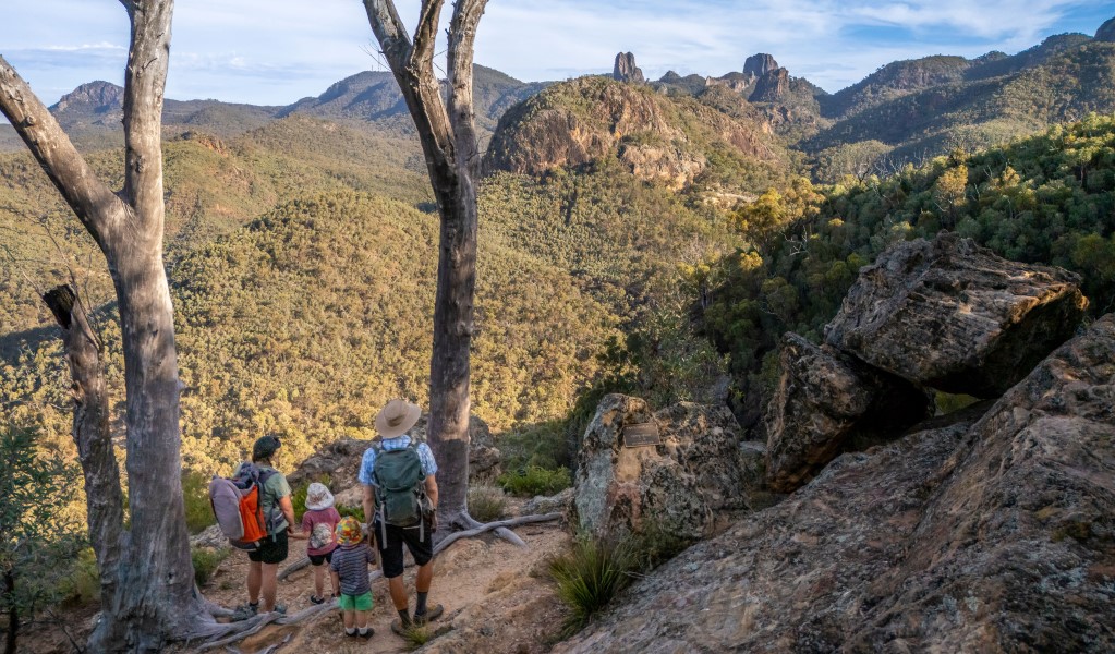 A family looking out at the view along Fans Horizon walking track in Warrumbungle National Park. Photo: John Spencer &copy; DCCEEW