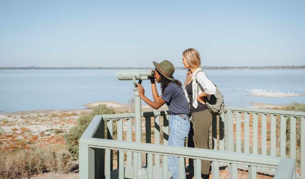 Two women using the view finder at Yanga Lake viewing deck in Yanga National Park. Credit: Ain Raadik &copy; DCCEEW/Balranald Shire 