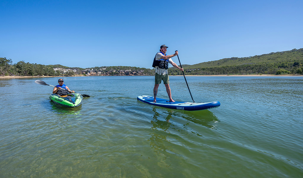 People kayaking and stand up paddle boarding on Wooli Wooli River. Credit: John Spencer &copy; DCCEEW