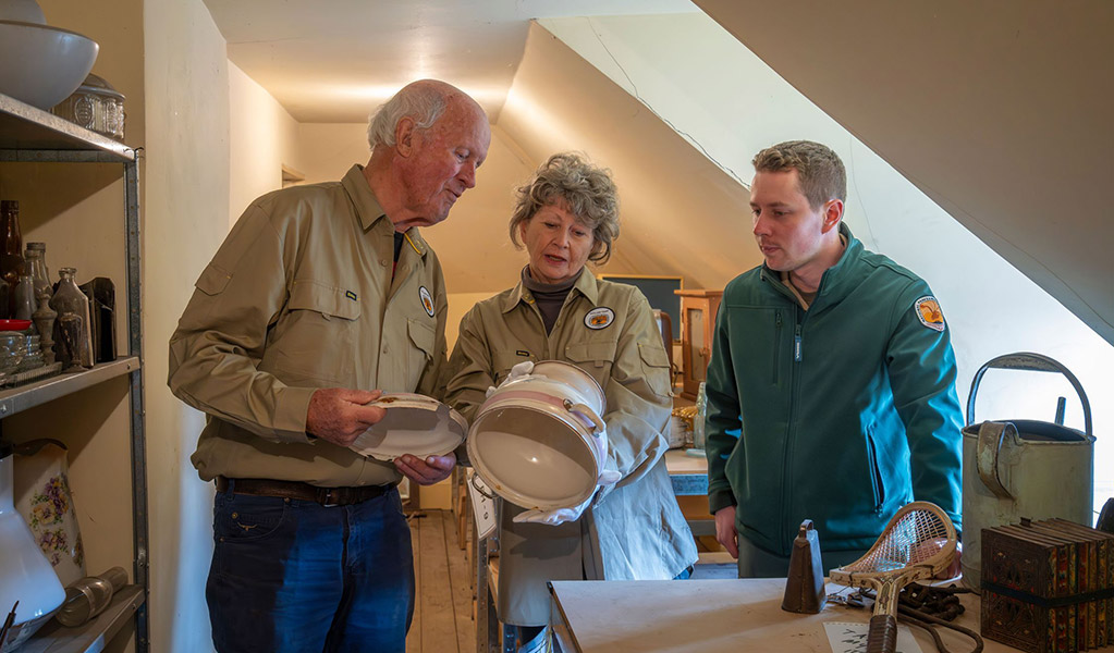 Two volunteers work with an NPWS staff member to identify a Hartley artefact, Hartley Historic Site. Credit: John Spencer/DCCEEW &copy; DCCEEW