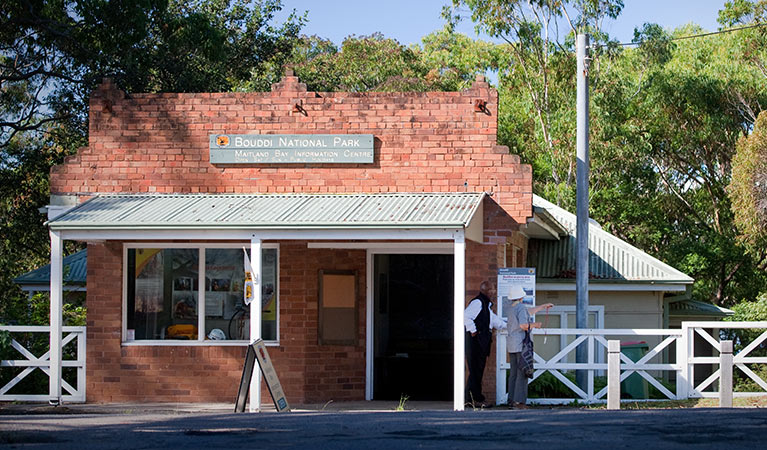 Volunteer assists visitor at Maitland Bay Information Centre, Bouddi National Park. Photo: Nick Cubbin